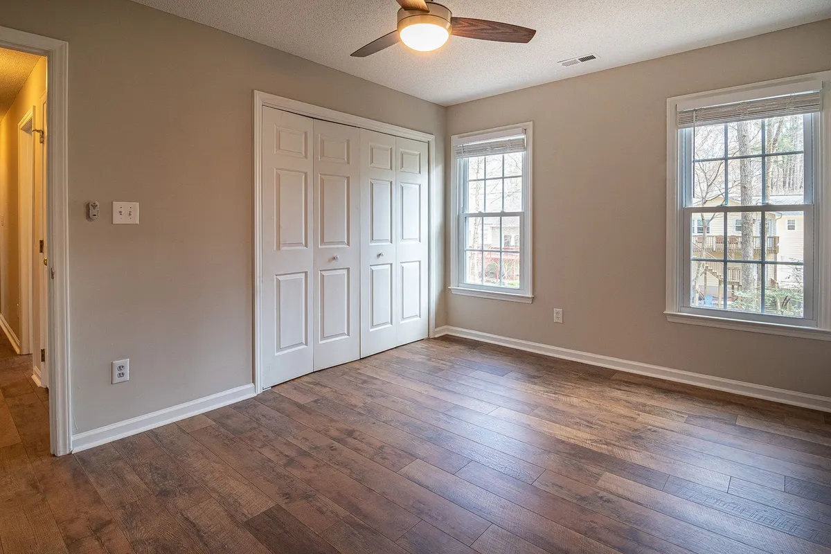 Wide-plank hardwood in a bright bedroom